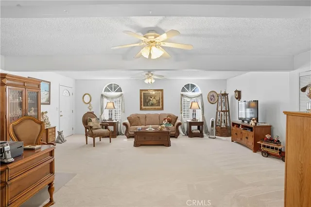 a living room with furniture gym equipment and a chandelier