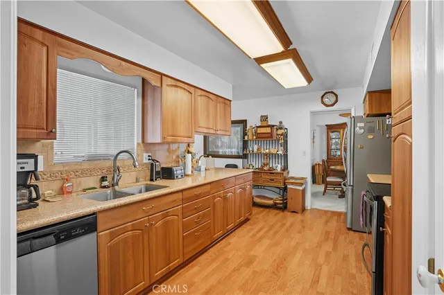 a kitchen with stainless steel appliances granite countertop a refrigerator stove and sink