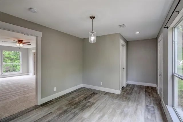 a view of a room with wooden floor and window