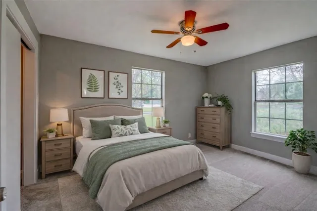 a bedroom with a bed closet and a large window