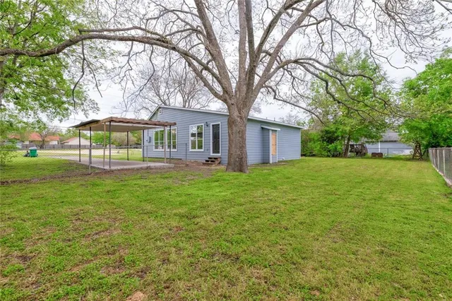 a front view of house with yard and green space
