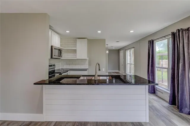 a view of living room with furniture and large windows