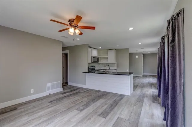 a view of a kitchen with a sink and a refrigerator