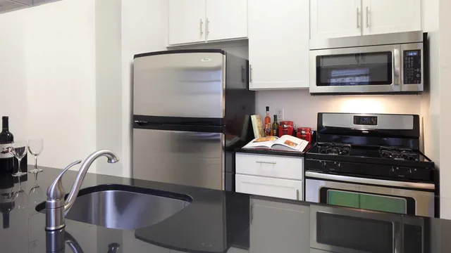 a kitchen with stainless steel appliances granite countertop a stove and a microwave