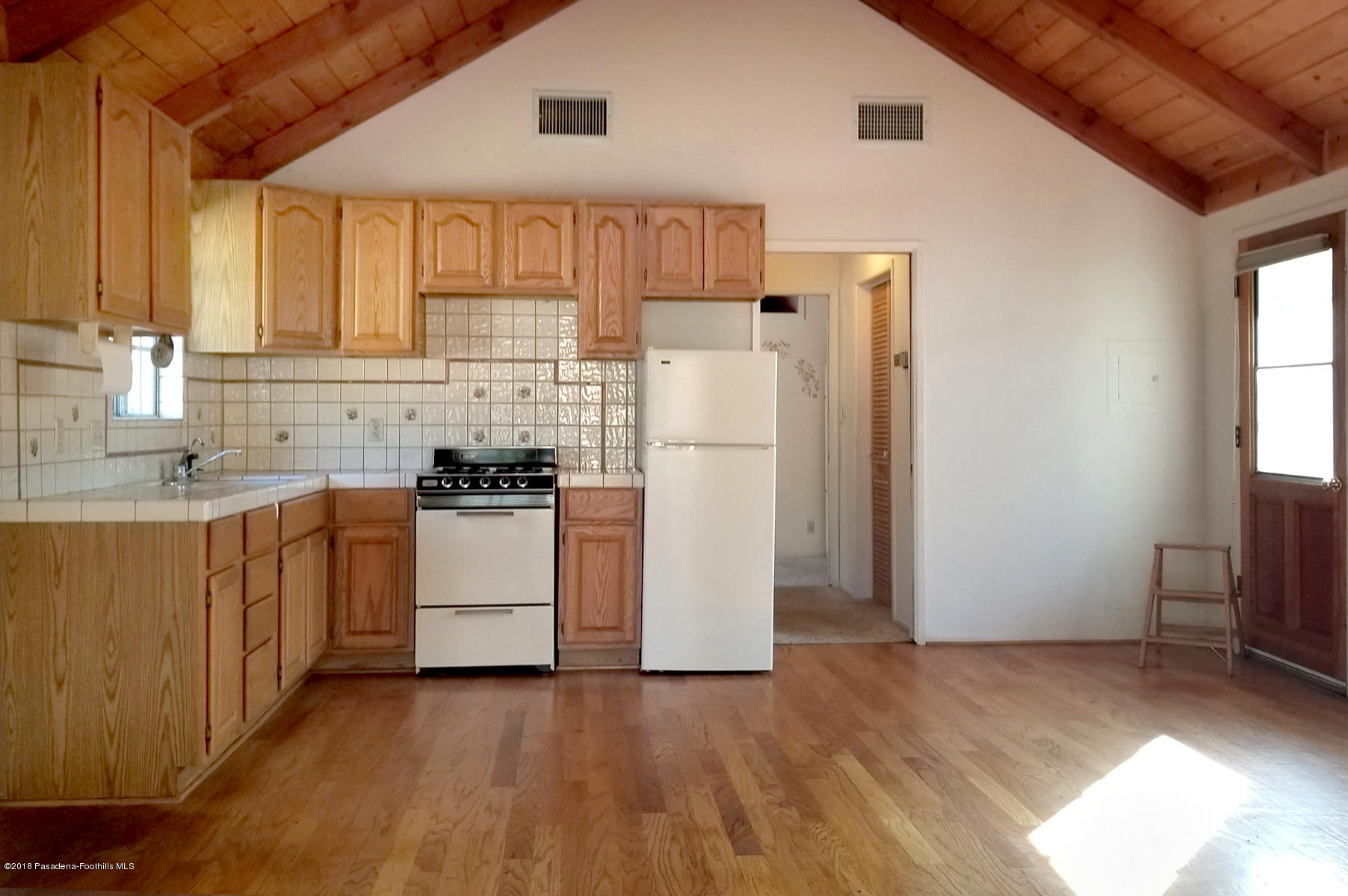 2011 Minoru Drive Altadena, CA 91001 - Photo 16 of 26 a kitchen with stainless steel appliances a refrigerator sink and cabinets