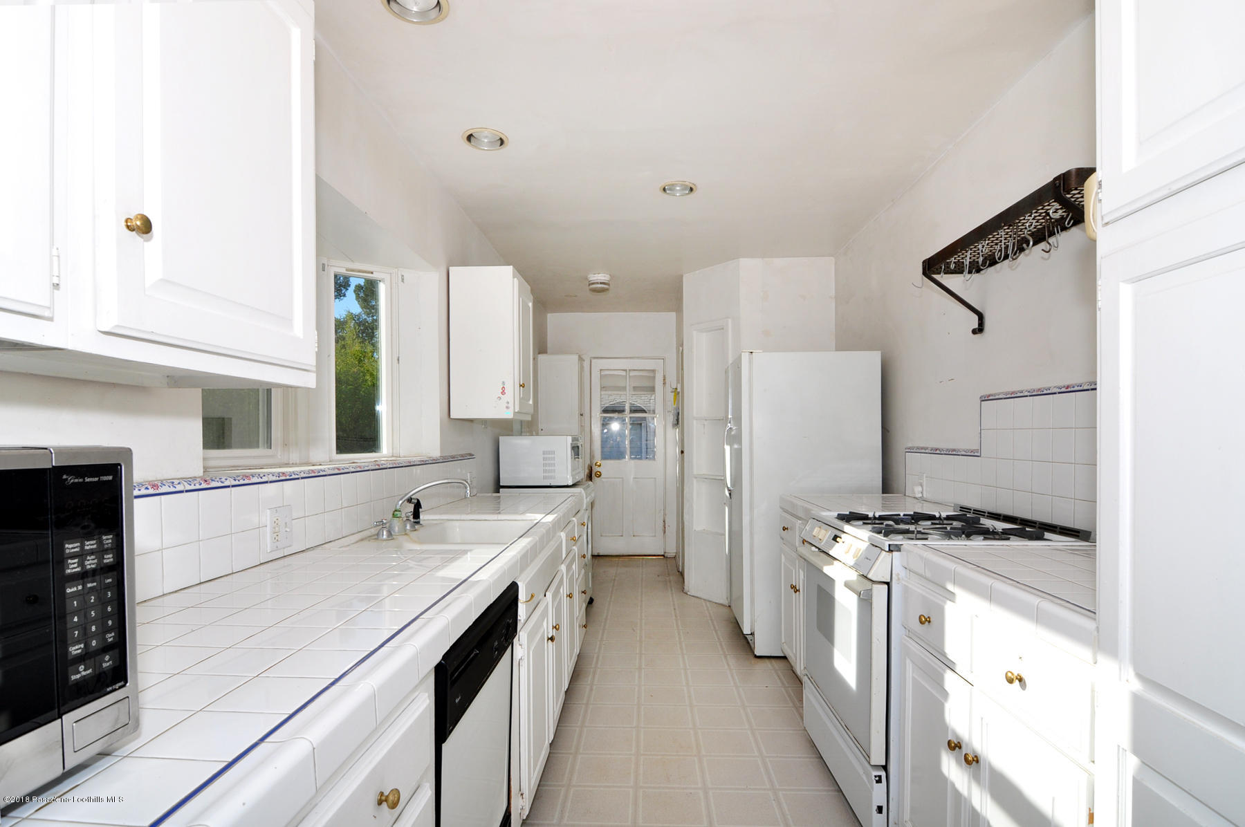 2011 Minoru Drive Altadena, CA 91001 - Photo 5 of 26 a kitchen with stainless steel appliances a sink stove and refrigerator