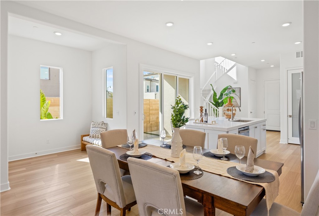 307 Baluster Irvine, CA 92618 - Photo 12 of 29 a dining room with furniture a window and wooden floor