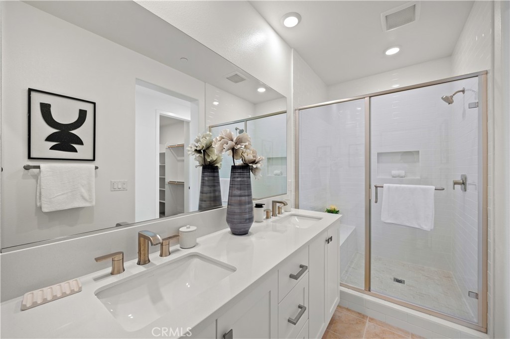 307 Baluster Irvine, CA 92618 - Photo 18 of 29 a bathroom with a double vanity sink mirror and shower