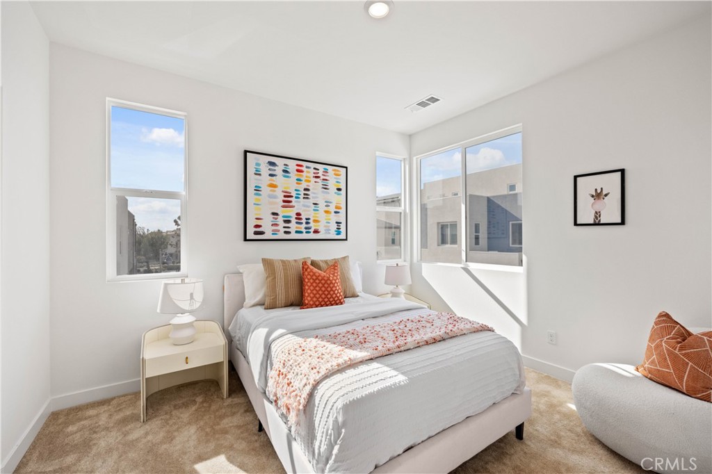 307 Baluster Irvine, CA 92618 - Photo 19 of 29 a bedroom with a bed and wooden floor