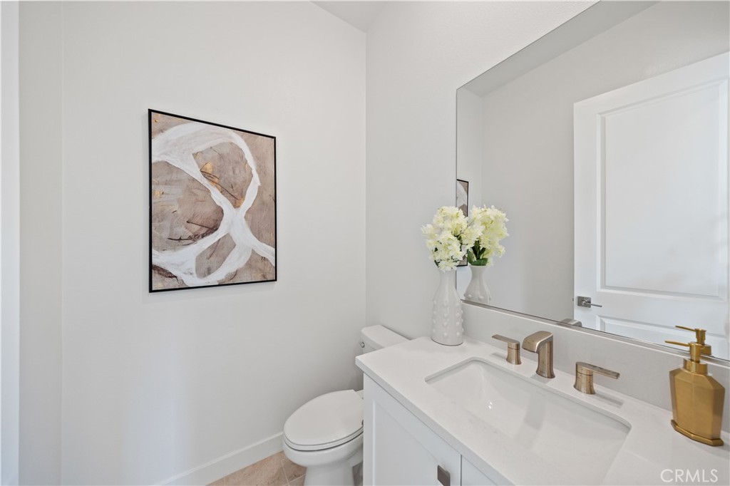 307 Baluster Irvine, CA 92618 - Photo 26 of 29 a bathroom with a toilet a sink and mirror