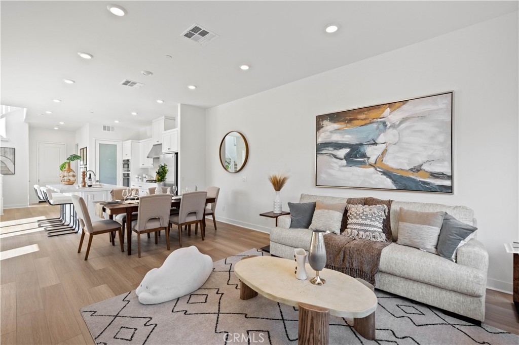 307 Baluster Irvine, CA 92618 - Photo 5 of 29 a living room with furniture kitchen view and a dining table
