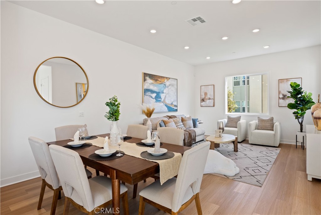 307 Baluster Irvine, CA 92618 - Photo 6 of 29 a living room with a couch dining table a rug and a potted plant