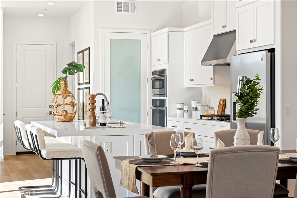 307 Baluster Irvine, CA 92618 - Photo 9 of 29 a living room with stainless steel appliances furniture a fireplace and a kitchen island