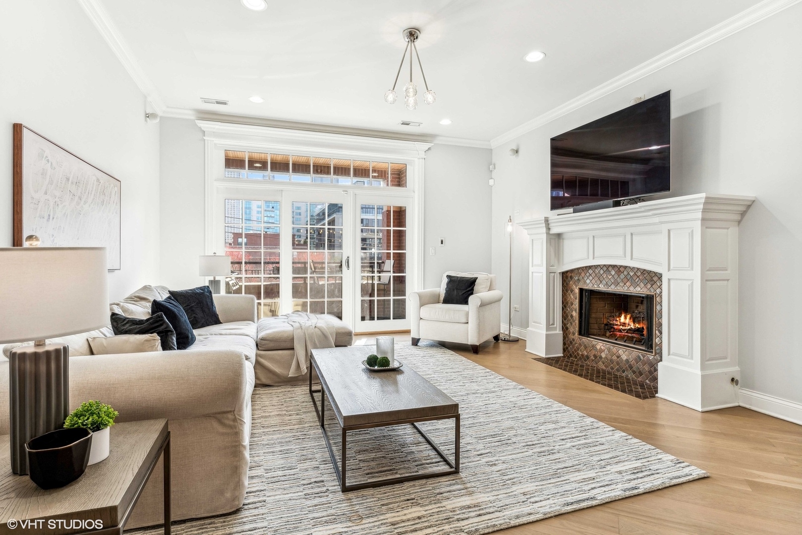 100 South Sangamon Street, Unit 3S Chicago, IL 60607 - Photo 3 of 26 a living room with furniture a flat screen tv and a fireplace