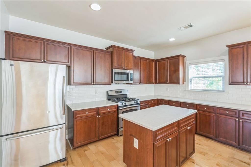 242 16th Street Northwest, Unit 14 Atlanta, GA 30363 - Photo 11 of 31 a kitchen with a stove a refrigerator and a sink