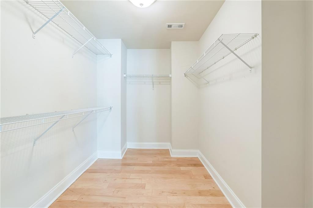 242 16th Street Northwest, Unit 14 Atlanta, GA 30363 - Photo 18 of 31 a view of an empty walk in closet with empty racks