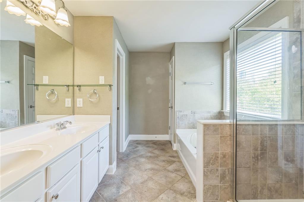 242 16th Street Northwest, Unit 14 Atlanta, GA 30363 - Photo 20 of 31 a spacious bathroom with a sink a mirror and a shower
