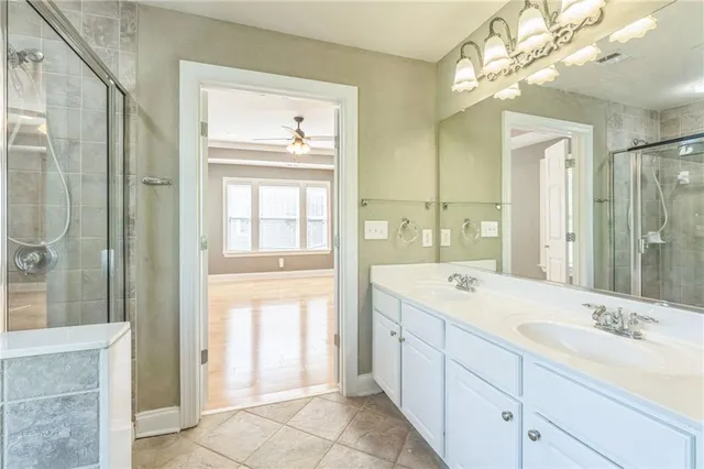 a spacious bathroom with a shower sink and mirror