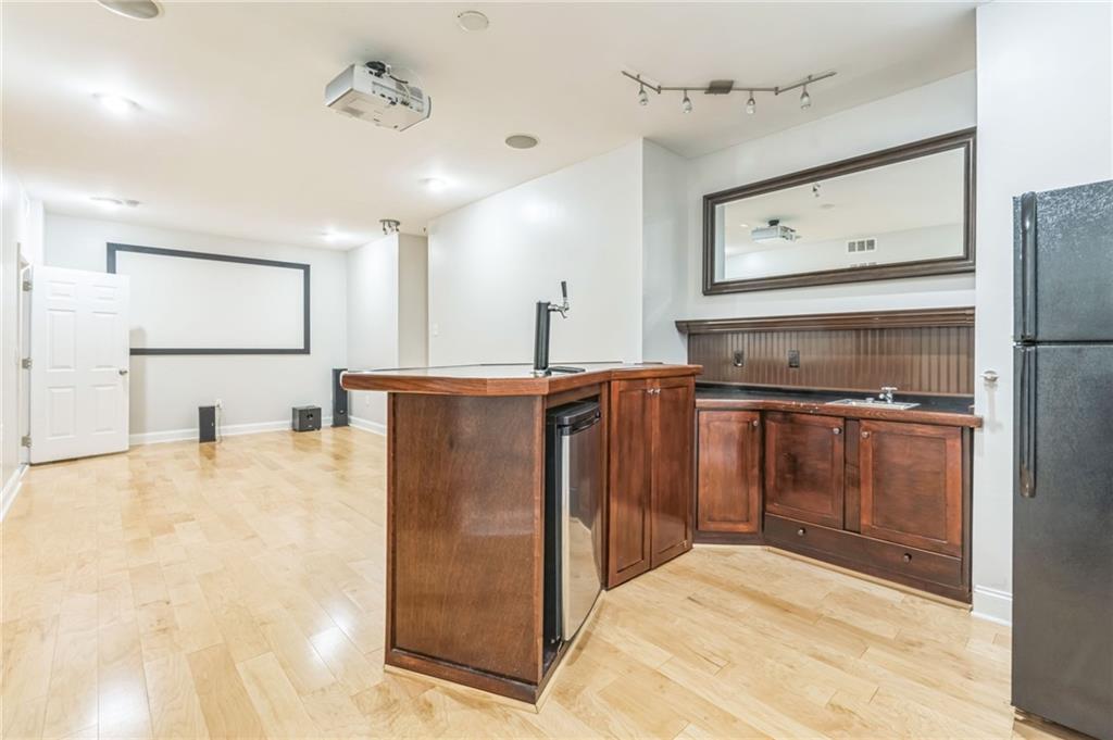 242 16th Street Northwest, Unit 14 Atlanta, GA 30363 - Photo 26 of 31 a kitchen with kitchen island a counter top space a sink stainless steel appliances and cabinets