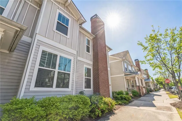 a view of a brick building next to a yard