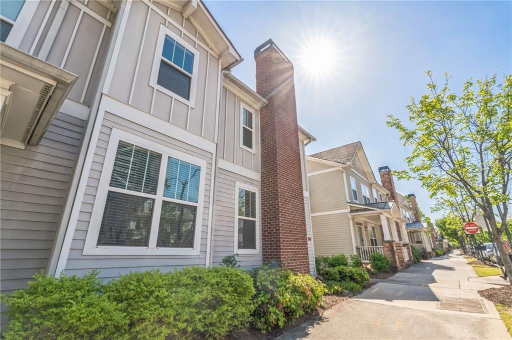 242 16th Street Northwest, Unit 14 Atlanta, GA 30363 - Photo 3 of 31 a view of a brick building next to a yard