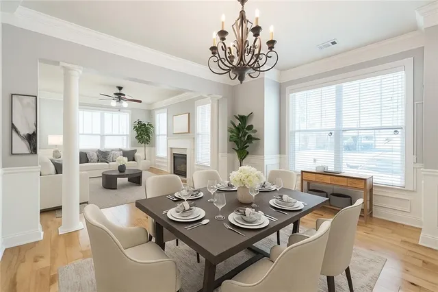 a view of a dining room with furniture wooden floor and chandelier