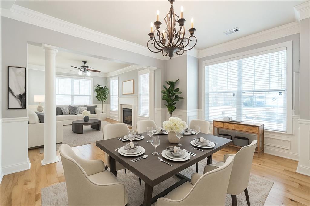 242 16th Street Northwest, Unit 14 Atlanta, GA 30363 - Photo 6 of 31 a view of a dining room with furniture wooden floor and chandelier
