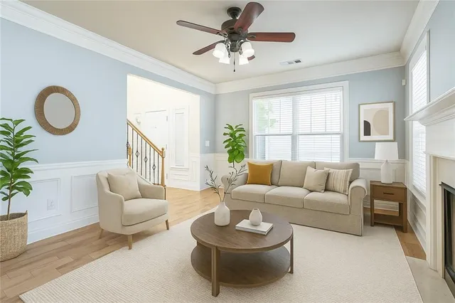a living room with furniture a fireplace and a large window