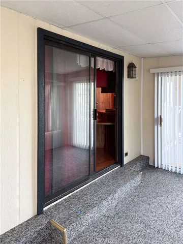 a view of a hallway with wooden shelves