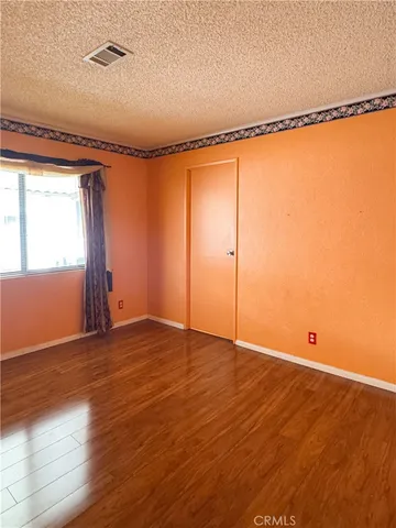 a bedroom with a bed and a mirror