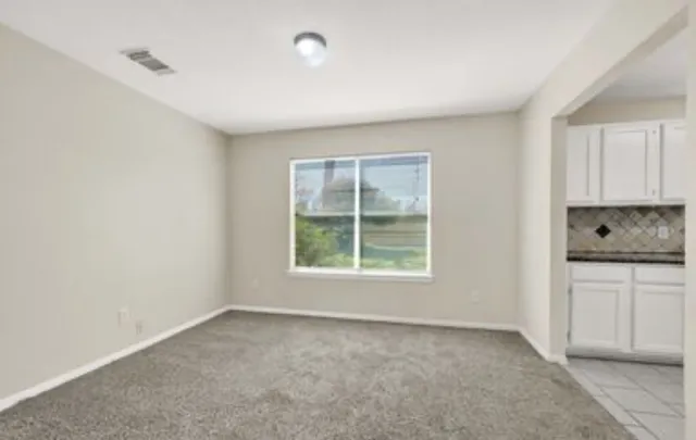 a big room with windows and a cabinet