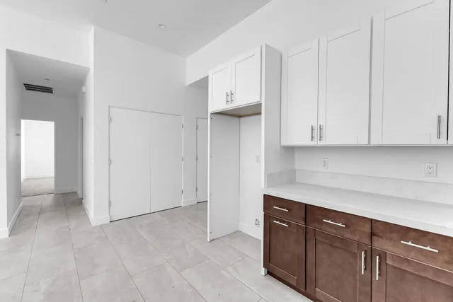 a view of a kitchen with a dishwasher and a fireplace