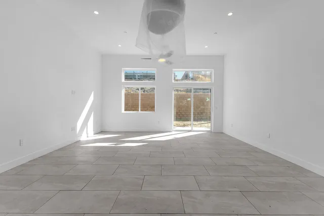 a large white kitchen with cabinet and a fireplace