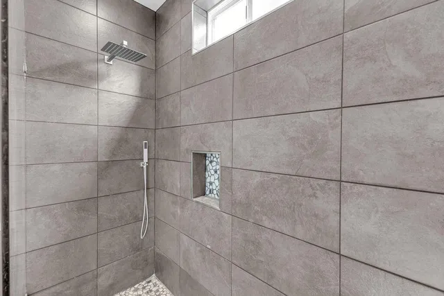 an empty room with windows and ceiling fan