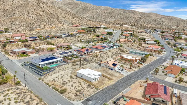 an aerial view of a house with a yard