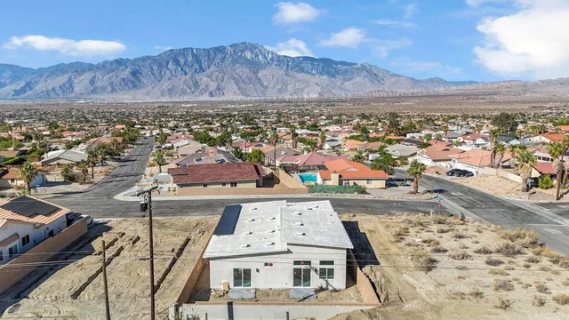 an aerial view of residential house and car parked in city