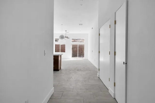 a kitchen with stainless steel appliances kitchen island a stove a sink a center island and a window