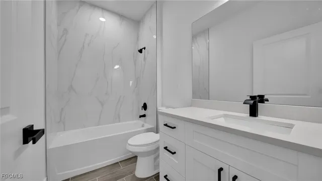 a bathroom with a sink a toilet and a tub