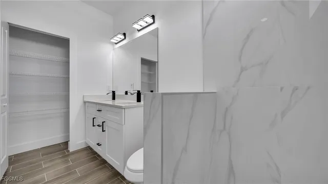 a bathroom with a sink a mirror and shower