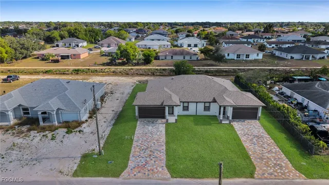 an aerial view of a house with garden space and lake view