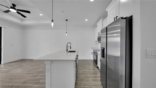 a kitchen with stainless steel appliances granite countertop a refrigerator and a sink