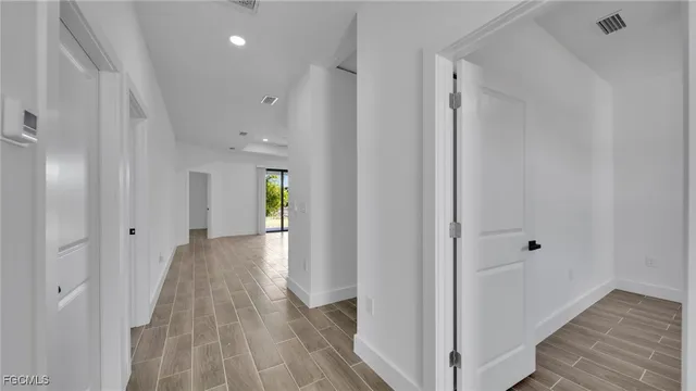 a view of a hallway with wooden floor