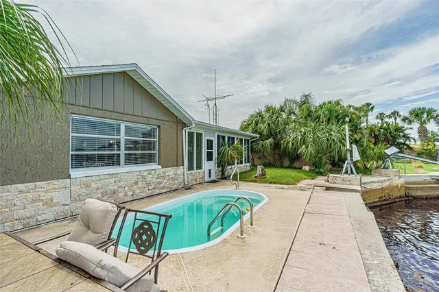 a view of house with swimming pool outdoor seating