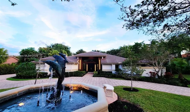 a view of a house with backyard and sitting area