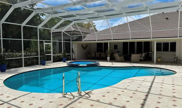 a view of a swimming pool with a lounge chair