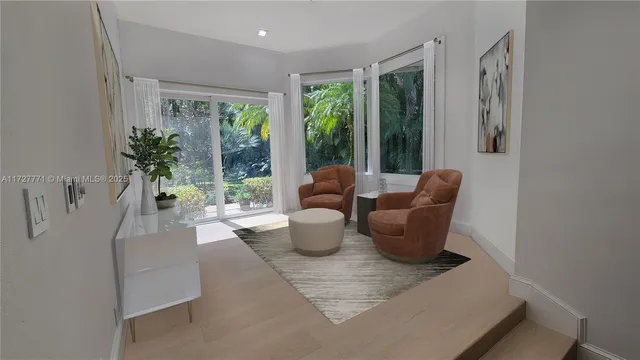 a living room with furniture and a potted plant