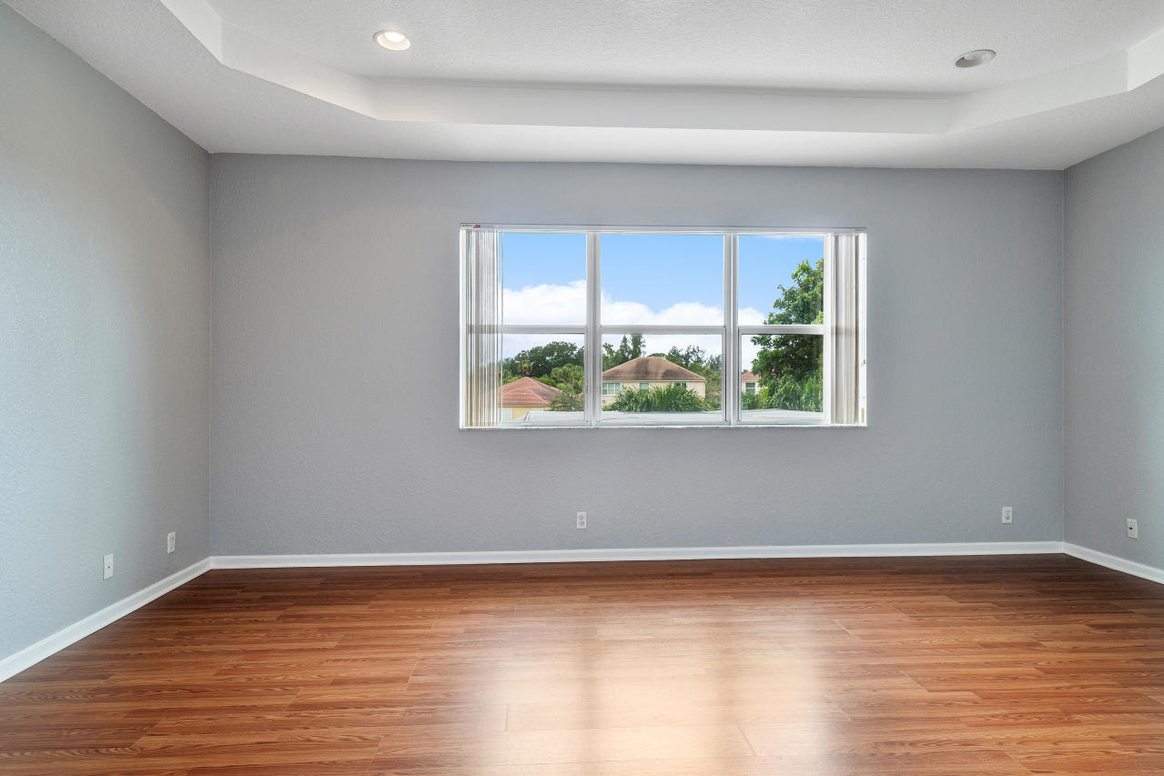 415 Mulberry Grove Road Royal Palm Beach, FL 33411 - Photo 15 of 39 a view of an empty room with wooden floor and a window