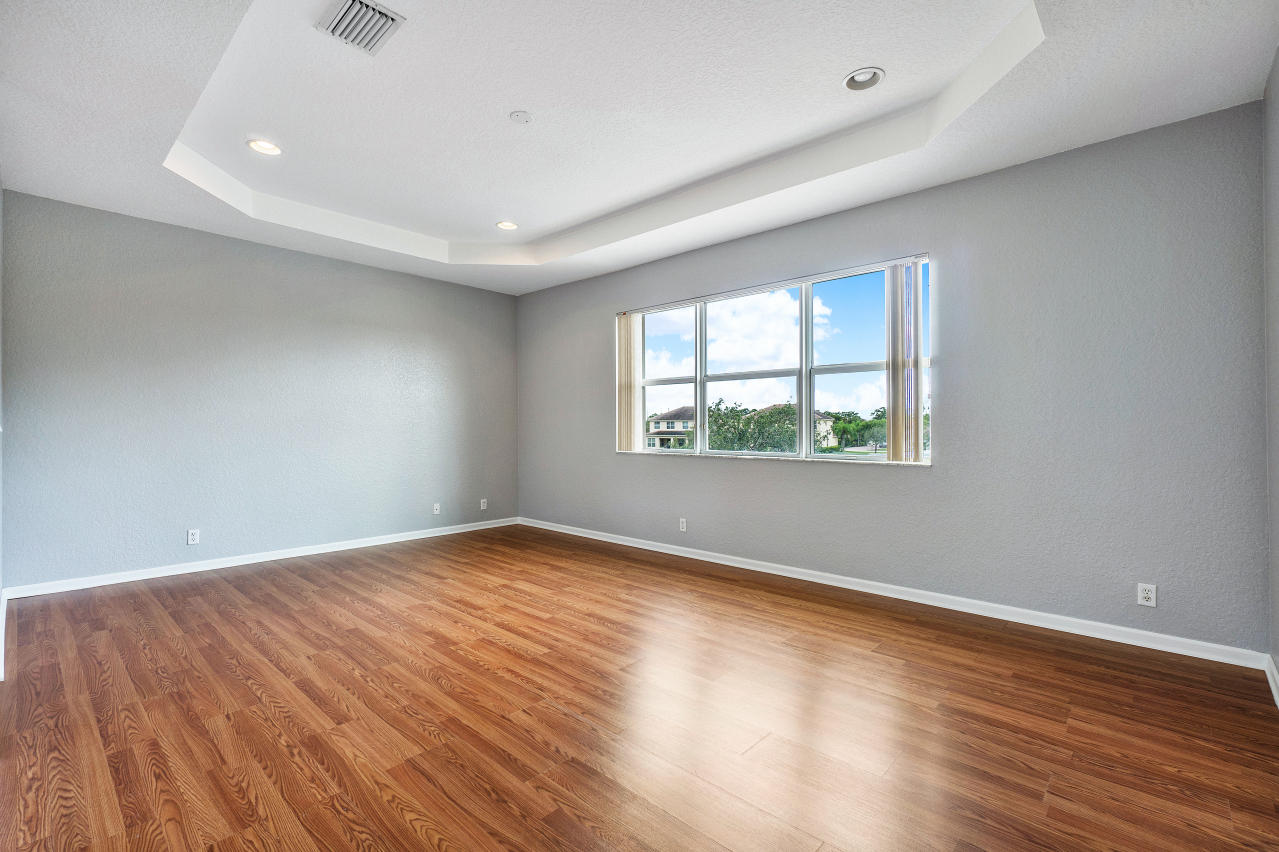 415 Mulberry Grove Road Royal Palm Beach, FL 33411 - Photo 16 of 39 an empty room with wooden floor and windows