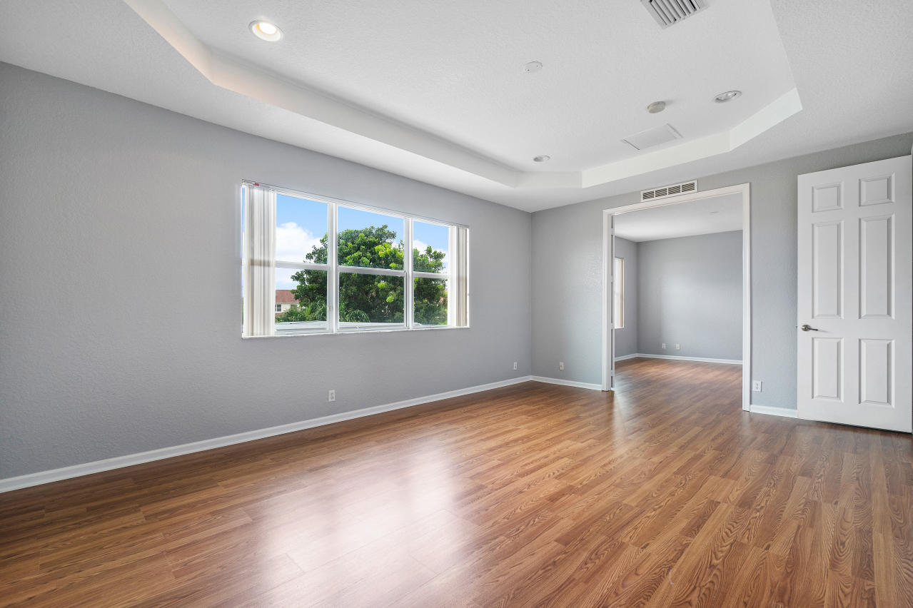 415 Mulberry Grove Road Royal Palm Beach, FL 33411 - Photo 19 of 39 a view of an empty room with wooden floor and a window