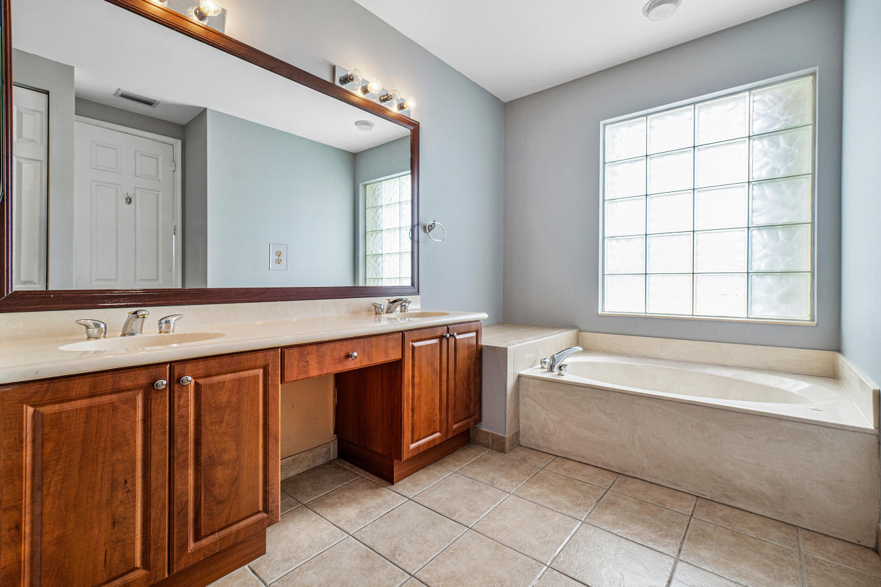415 Mulberry Grove Road Royal Palm Beach, FL 33411 - Photo 22 of 39 a spacious bathroom with a large tub sink and mirror